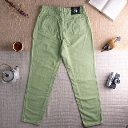 back view Vintage Versace Jeans Couture 90s Lime Green Trousers – sage lime green textured cotton, high waist, five-pocket mom fit, silver Medusa logo button, straight leg silhouette, Versace Jeans Couture label at waistband, flat lay editorial shot