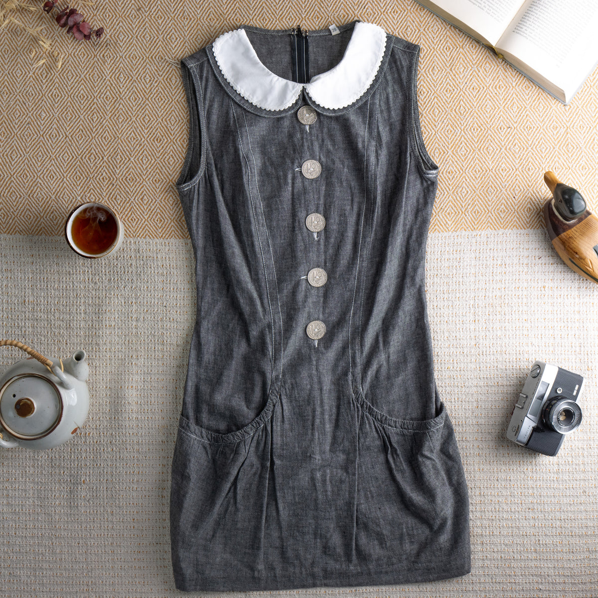 Archival Fendissime by Fendi 1987 Mod Mini Dress – dark grey chambray denim, white scalloped Peter Pan collar, sleeveless, four large silver Fendi logo coin buttons at centre front, vertical seam panelling, two hip patch pockets, body-con silhouette, Karl Lagerfeld era, flat lay editorial shot