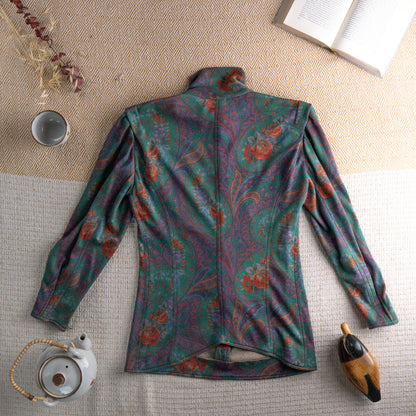 back Vintage Ungaro Parallèle Paris 80s Two-Piece Skirt Suit – emerald green, rust and mauve paisley floral jersey, high neck blouse with jewel button-front and dramatic puff shoulders, long sleeves, matching high-waist pencil midi skirt, Made in Italy, flat lay editorial shot