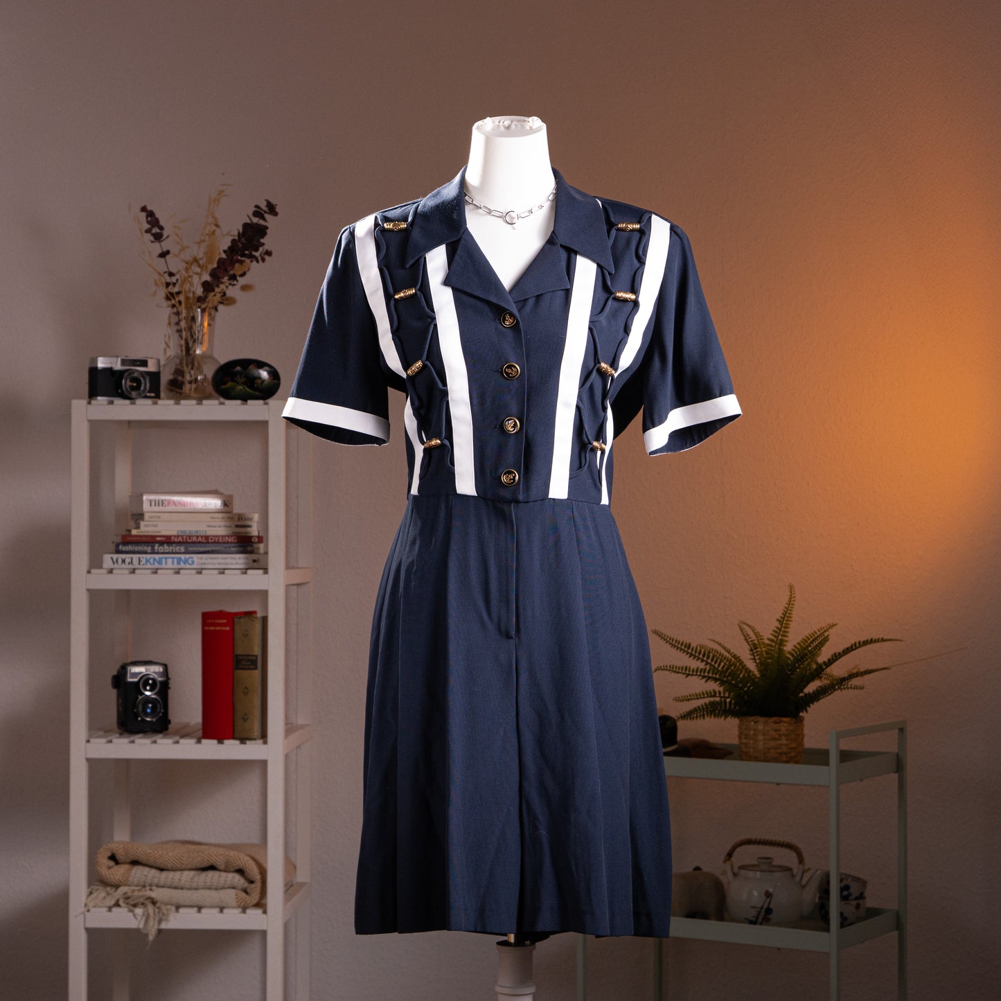 Archival Joseph Ribkoff 80s Nautical Deadstock Jumpsuit – navy blue with white vertical stripe trompe l'oeil panel detail, gold nautical rope and anchor button trim, notched lapel collar, short sleeves, pleated wide-leg trousers, strong shoulder silhouette, product shot on dress form