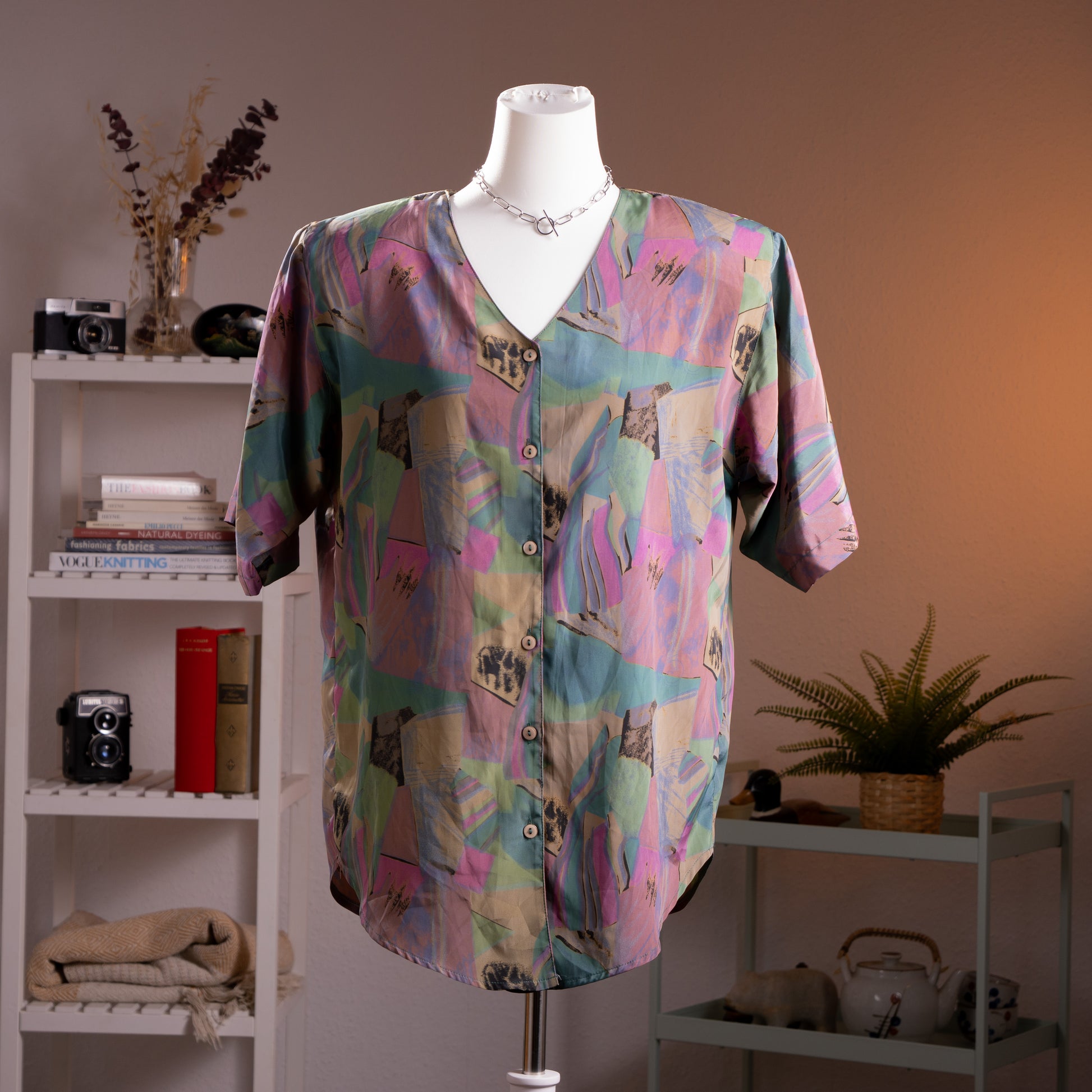 Archival Christian Dior by Gianfranco Ferré 90s Oversized Silk Blouse – abstract watercolour print in pastel pink, teal, lavender and sage green with figurative collage motifs, V-neckline, short sleeves, double-sided avant-garde button construction, relaxed boxy silhouette, product shot on dress form