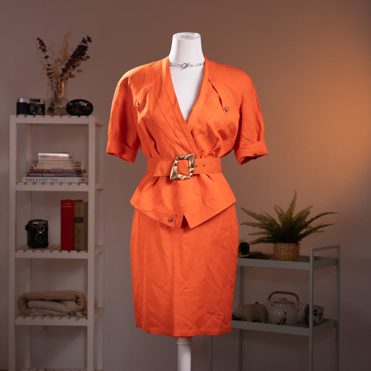 Archival Thierry Mugler ACTIV 1992 3-Piece Skirt Suit – vibrant coral orange linen blend, structured wrap blazer with deep V-neckline, short sleeves, gold pyramid hardware stud buttons, matching wide belt with large gold pyramid buckle for extreme wasp waist silhouette, pencil mini skirt, product shot on dress form
