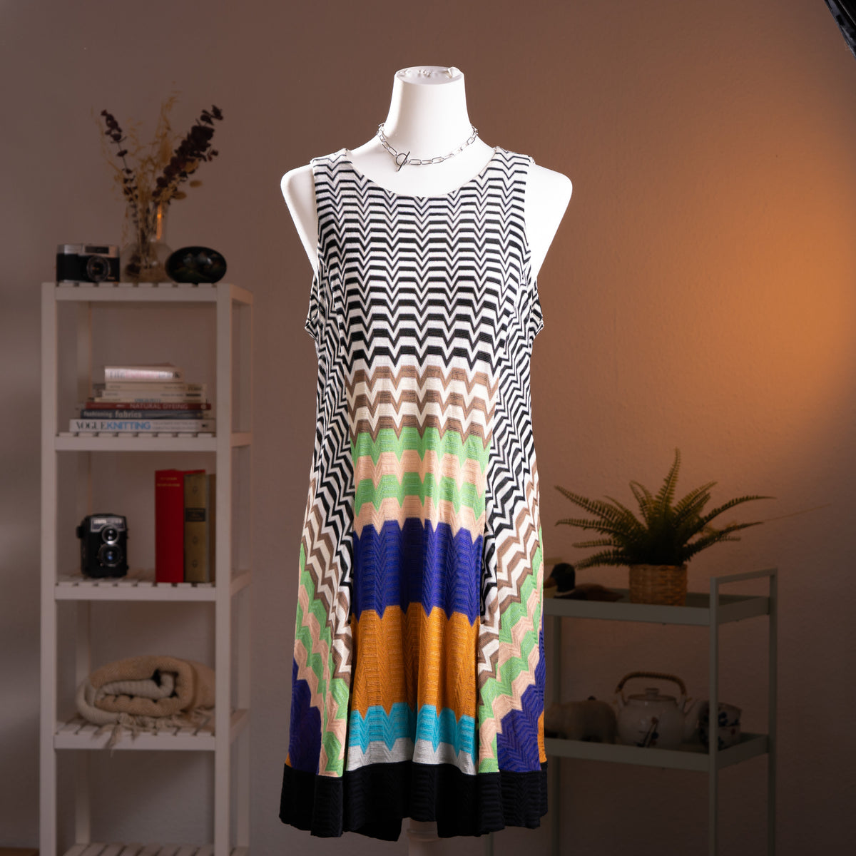 Archival Missoni Angela Missoni Era Y2K Chevron Knit Mini Dress – bold colour block optical illusion knit with black and white zigzag chevron at shoulders transitioning into concentric arch panels in mint green, cream, cobalt blue, amber orange and turquoise, sleeveless, keyhole back, straight shift silhouette, Made in Italy, product shot on dress form