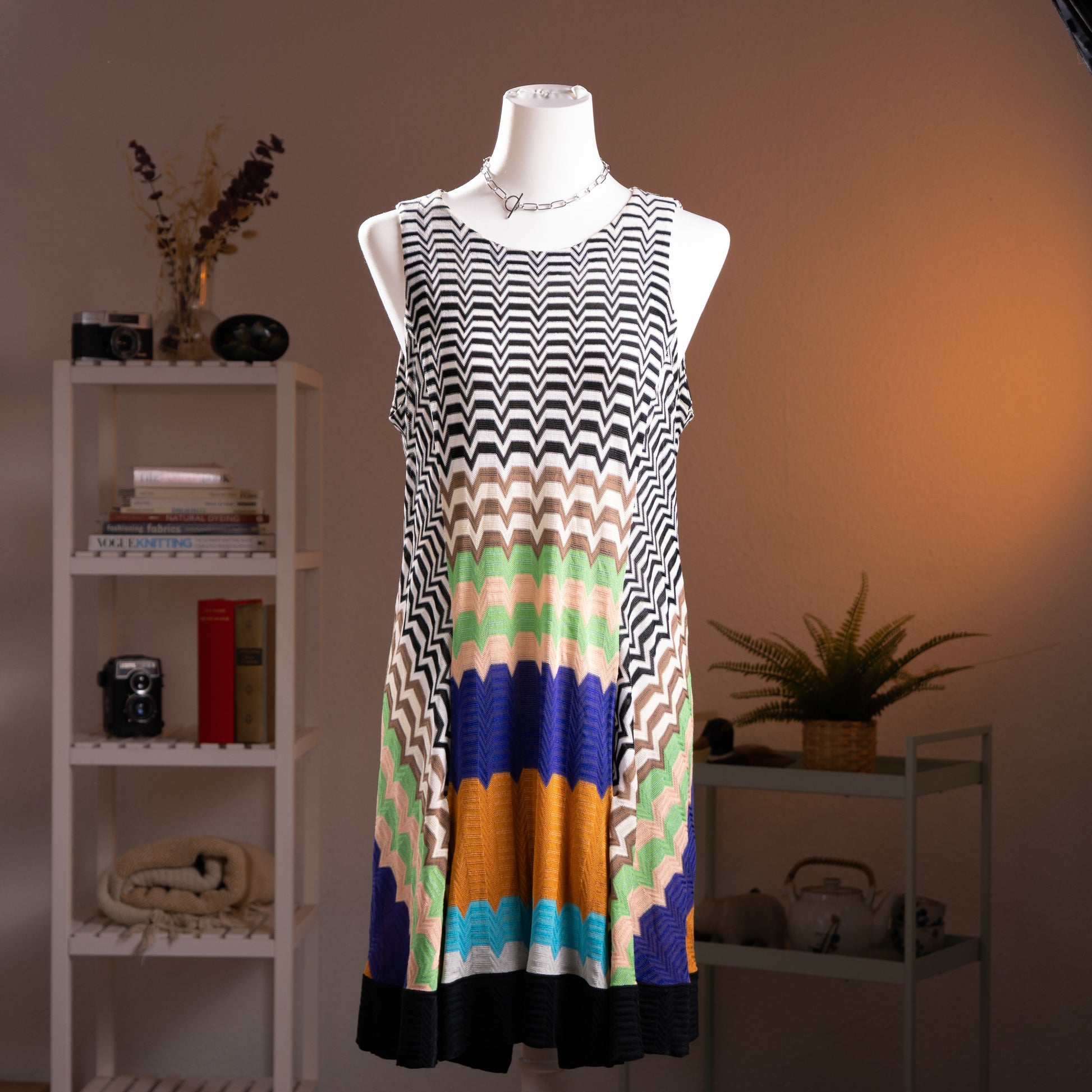 Archival Missoni Angela Missoni Era Y2K Chevron Knit Mini Dress – bold colour block optical illusion knit with black and white zigzag chevron at shoulders transitioning into concentric arch panels in mint green, cream, cobalt blue, amber orange and turquoise, sleeveless, keyhole back, straight shift silhouette, Made in Italy, product shot on dress form