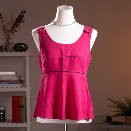 Archival Salvatore Ferragamo Fuchsia Pure Linen Peplum Top – vibrant fuchsia pink linen with scoop neckline, wide shoulder straps with woven wood toggle button detail, navy blue contrast piping trim at empire waist seam, flared peplum hem, silk lined, Made in Italy, product shot on dress form