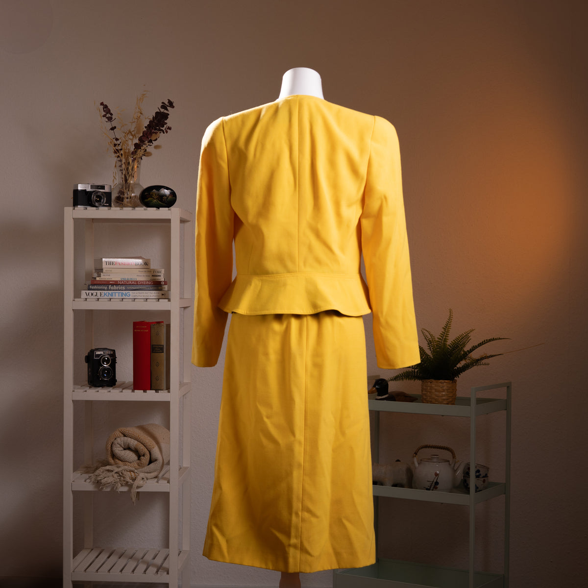 back view Archival Louis Féraud Paris NOS Deadstock 80s Power Suit – canary yellow two-piece skirt suit with structured strong-shoulder cropped blazer, black contrast lapel trim and single gold button, matching midi pencil skirt with front kick pleat, Made in West Germany, product shot on dress form