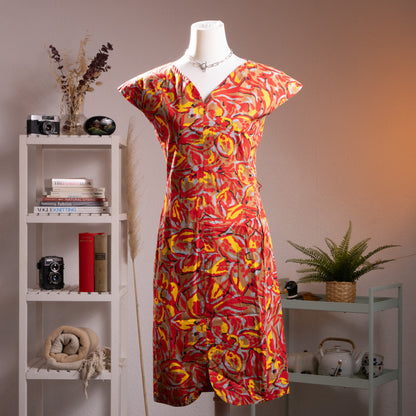 Pierre Balmain Paris 1970s NOS Deadstock Cotton Dress – bold abstract floral print in red, yellow, grey and black on 100% cotton, deep V-neckline with gathered detail, cap sleeves, A-line midi silhouette, French luxury curator find, product shot on dress form