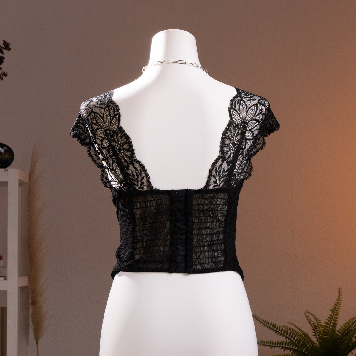 back view Archival La Perla 90s NOS Plissé Sculpt Bustier Corset Top – black pleated satin with crossover draped sweetheart bodice, sheer floral Leavers lace illusion neckline and cap sleeves with scalloped trim, boned corset structure, museum quality Italian lingerie, product shot on dress form