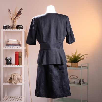 back view Archival Loris Azzaro Paris 80s NOS Power Suit – black cotton jacquard two-piece skirt set, structured blazer with deep V-neckline, zigzag lapel detail, two-button waist closure, short sleeves, peplum hem, matching A-line midi skirt, museum quality, product shot on dress form