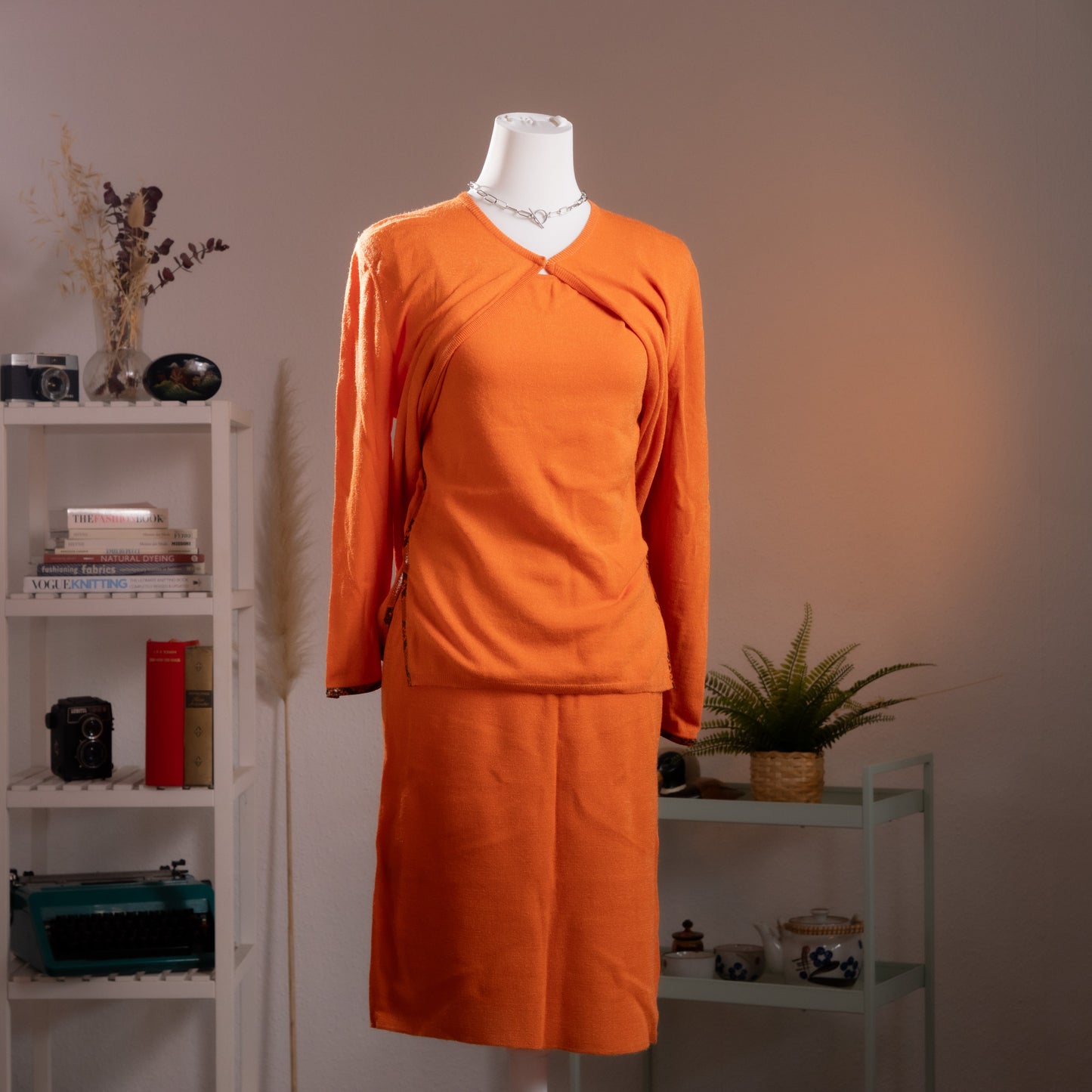 Archival Gianni Versace 1990s 3-Piece Cyber Futuristic Knit Set – saturated neon orange fine knit, crossover wrap V-neckline top with single gold Versace Medusa button, ruched side seam detail, long sleeves; matching midi pencil skirt with snake-embossed leather trim waistband; Gilmar BVM label, futuristic skirt suit, product shot on dress form