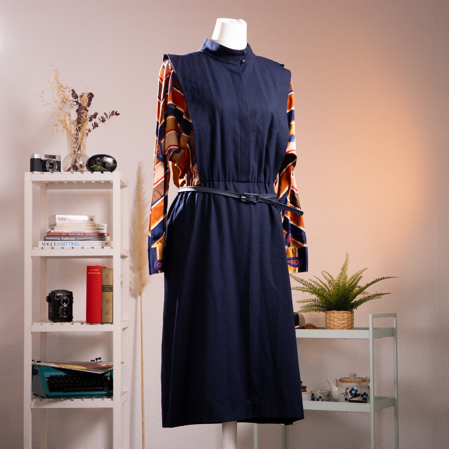 Archival Karl Lagerfeld 1974 Debut Mainline Impression Midi Dress – navy blue wool crepe body with trompe l'oeil geometric paisley print silk twill sleeves in navy, rust, orange and red, mock turtleneck with snap button, elasticated waist with thin leather belt, midi length, product shot on dress form