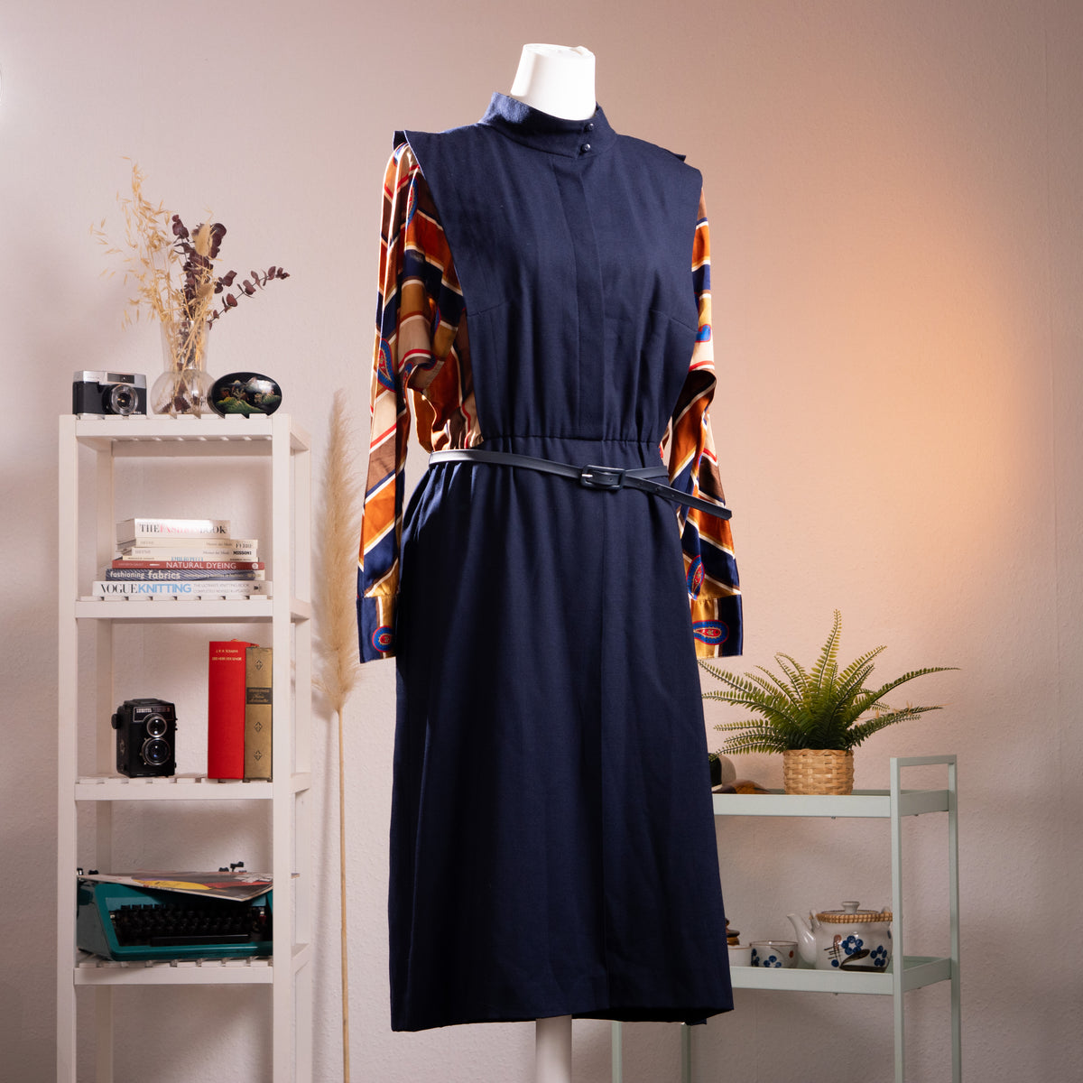 Archival Karl Lagerfeld 1974 Debut Mainline Impression Midi Dress – navy blue wool crepe body with trompe l'oeil geometric paisley print silk twill sleeves in navy, rust, orange and red, mock turtleneck with snap button, elasticated waist with thin leather belt, midi length, product shot on dress form