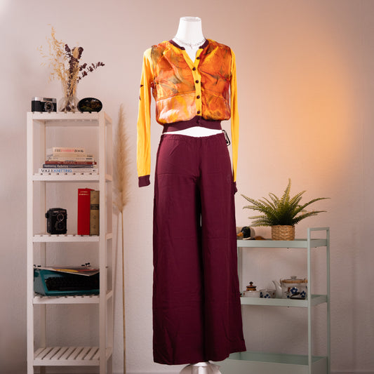 Archival Jean Paul Gaultier SS 2002 Maille Femme Two-Piece Set – mustard yellow cropped cardigan with sheer watercolour print mesh overlay in amber and green tones, burgundy contrast trim at neckline and cuffs, paired with wide-leg burgundy trousers with side tie detail, product shot on dress form