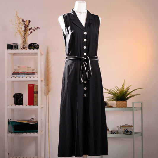 Archival KL by Karl Lagerfeld 1990s Minimalist Trench Maxi Dress – sleek black viscose-silk sleeveless dress with notched lapel collar, single-breasted front with white contrast buttons, white contrast piping trim, tie belt at waist with striped ribbon, maxi length, product shot on dress form