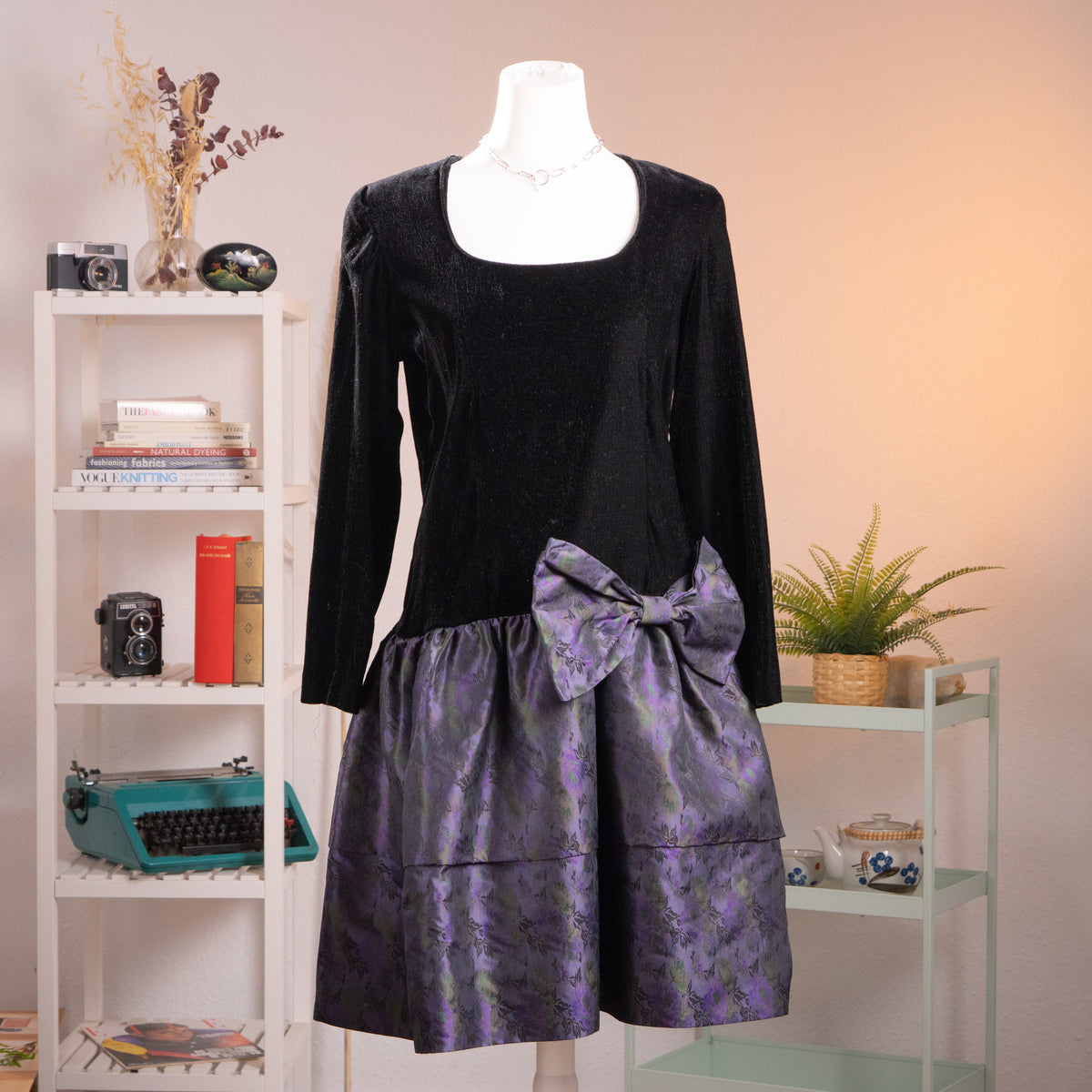 Front view of an archival KL by Karl Lagerfeld black crêpe and iridescent purple silk jacquard balloon dress from the late 1980s on a mannequin.