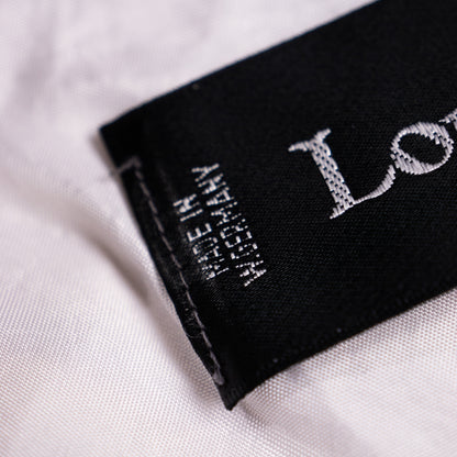 Close-up of the vintage Louis Féraud black woven satin neck label with vertical 'Made in W. Germany' text and European size matrix matrix D 40 US 10.
