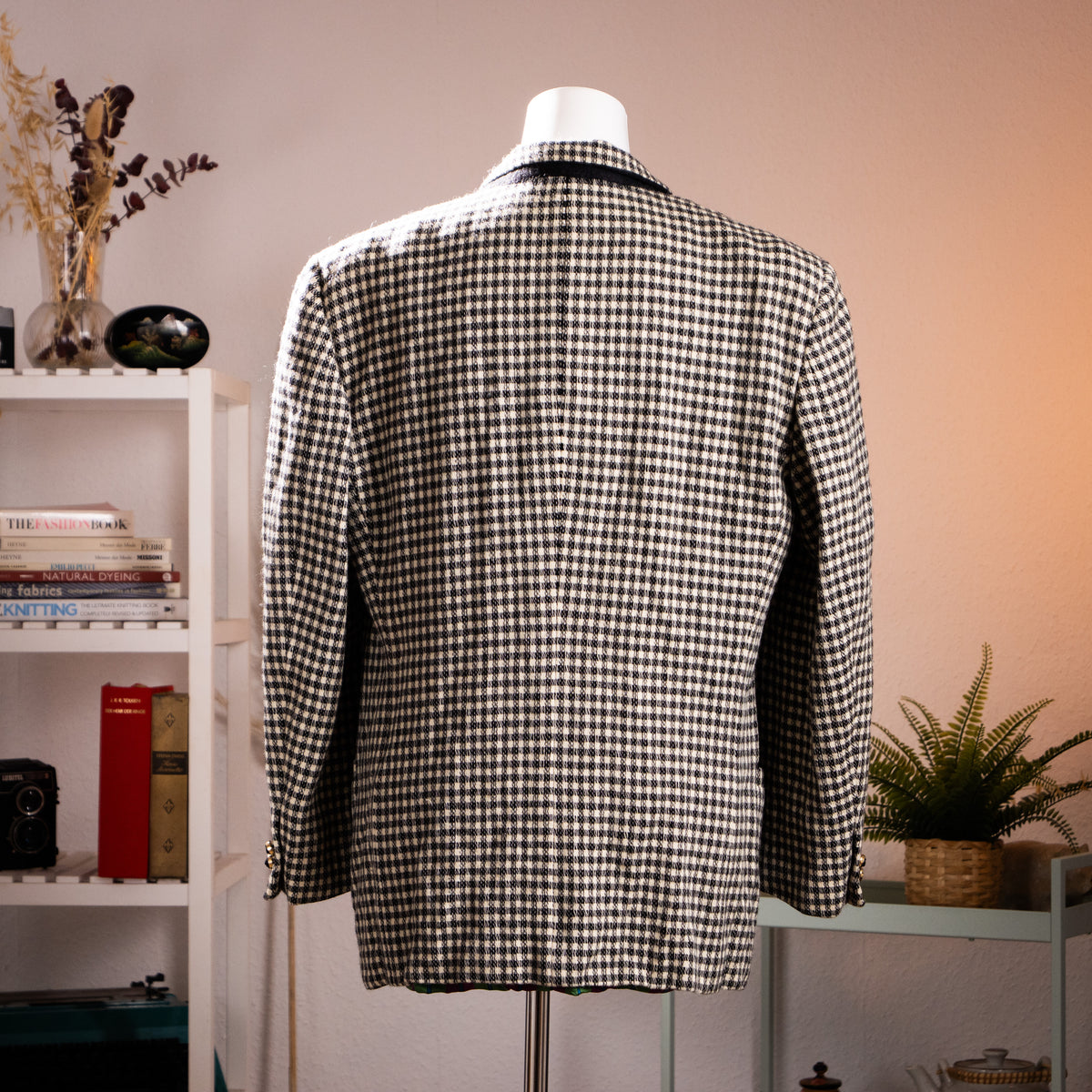 Rear view of the vintage Versus Gianni Versace monochrome check jacket showcasing the structured 90s power shoulders.

