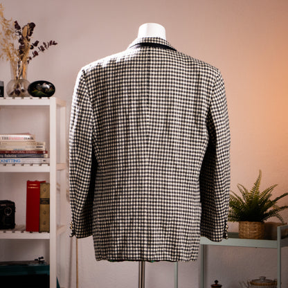 Rear view of the vintage Versus Gianni Versace monochrome check jacket showcasing the structured 90s power shoulders.
