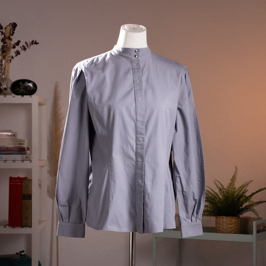 Archival Thierry Mugler Paris sculptural shirt blouse from the early 1990s runway era, featuring a hidden snap placket and statement collar, front view.
