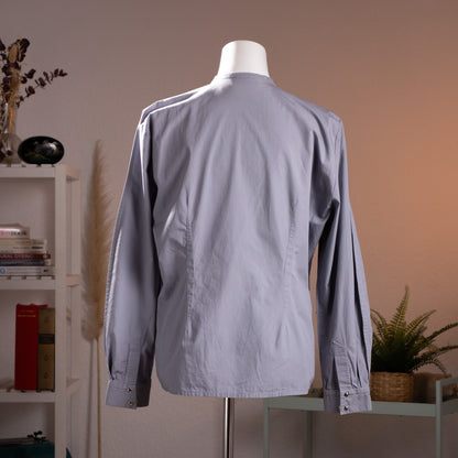Rear view of the vintage Thierry Mugler blouse showcasing the precise architectural contour darts and dramatic wasp-waist silhouette.
