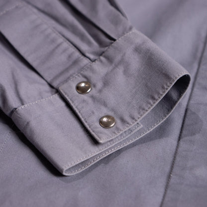 Detailed macro shot of the high-cuff sleeve tailoring and flawless fabric matrix of the archival Thierry Mugler garment.
