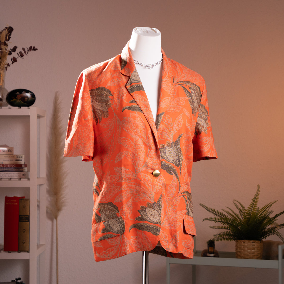 Archival Genny by Gianni Versace printed terracotta orange flax linen short-sleeve blazer from the early 1990s, front view on a gallery mannequin.
