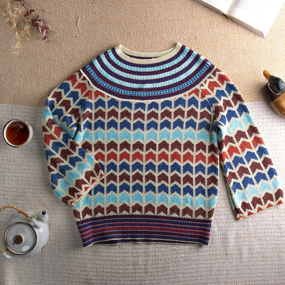 back view Archival 90s Chevron Lurex Metallic Knit Sweater – cream base with all-over zig zag chevron intarsia pattern in cobalt blue, rust red, chocolate brown and sky blue lurex metallic yarn, striped ribbed crew neck and hem, long sleeves, disco glamour editorial vintage, flat lay editorial shot
