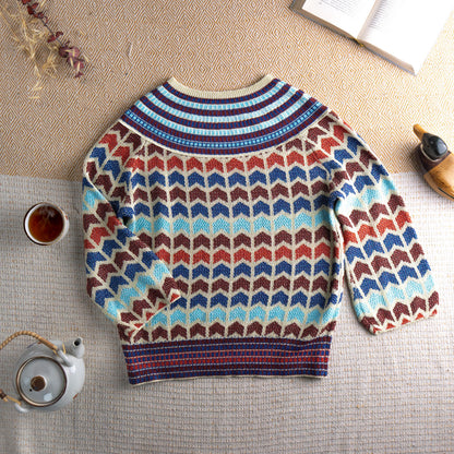 Archival 90s Chevron Lurex Metallic Knit Sweater – cream base with all-over zig zag chevron intarsia pattern in cobalt blue, rust red, chocolate brown and sky blue lurex metallic yarn, striped ribbed crew neck and hem, long sleeves, disco glamour editorial vintage, flat lay editorial shot