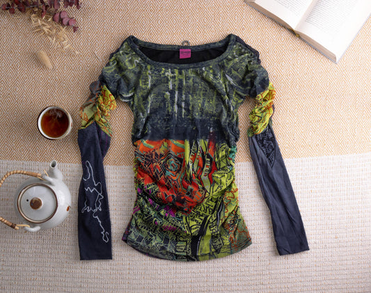 Vintage Save the Queen Y2K Sheer Mesh Long Sleeve Top – mixed media patchwork construction, dark charcoal grey mesh bodice with abstract grunge forest print, ruched centre front panel with psychedelic city map print in red, yellow and green, contrasting navy blue jersey sleeves with white outline print, wide scoop neckline, fairy core maximalist aesthetic, flat lay editorial shot