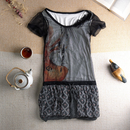 Rare Cop Copine "Geiko" Y2K Archival Mesh Mini Dress – sheer black tulle overlay bodice with large-scale abstract geisha face graphic print in grey, rust and terracotta, black lace short sleeves with floral appliqué at neckline, white jersey underlayer, black waistband, gathered bubble hem skirt in black and white geometric star pattern, avant-garde French designer, flat lay editorial shot