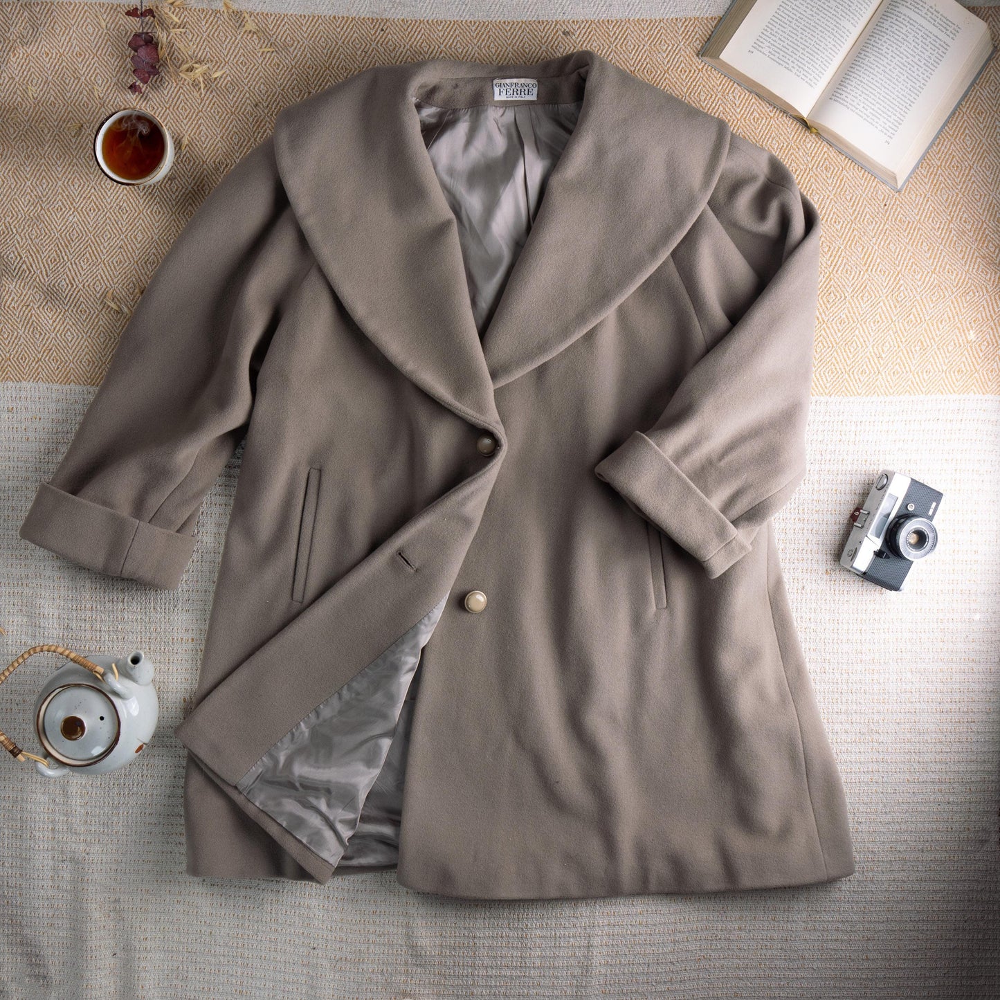 Archival Gianfranco Ferré Late 1980s Architectural Shawl Collar Cocoon Coat – warm taupe greige fine wool, oversized sculptural shawl collar, single large pearl button closure, two vertical welt pockets, wide turn-back cuffs, cocoon silhouette with silver satin lining, Gianfranco Ferré mainline woven label, rare masterpiece, flat lay editorial shot
