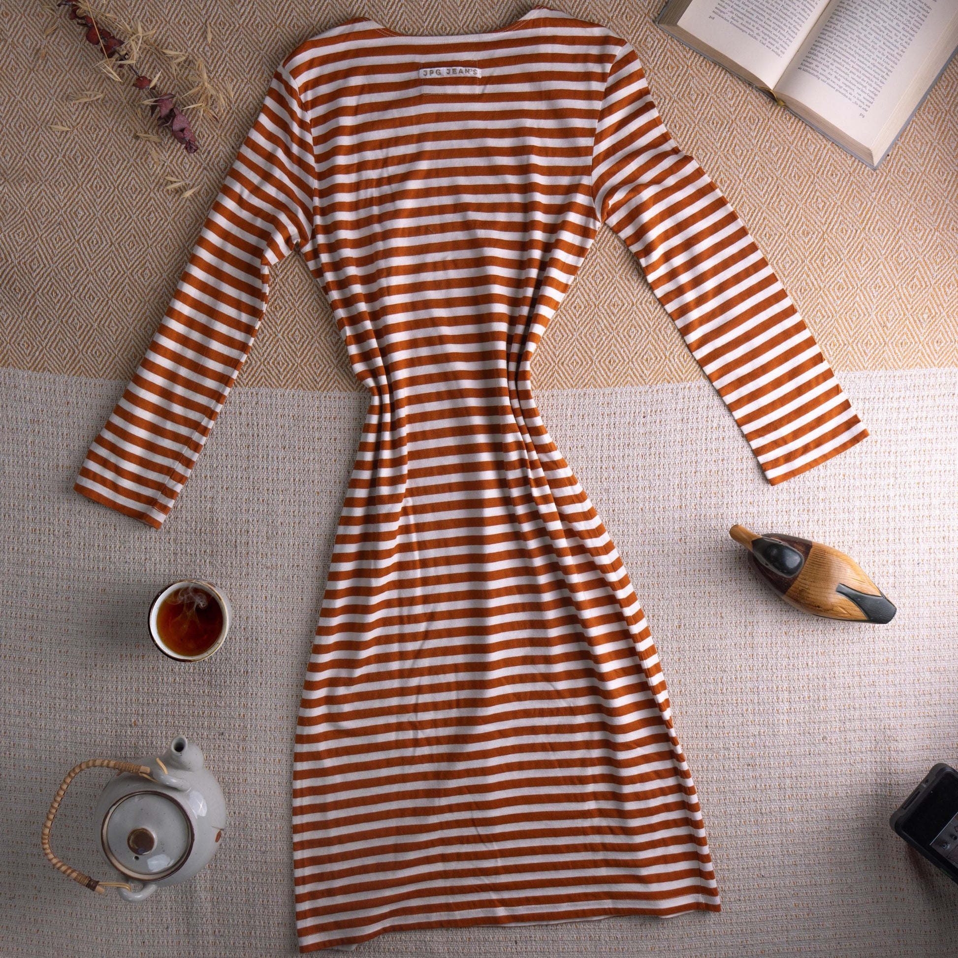 back view Jean Paul Gaultier JPG Jean's Archival 90s Marinière Stripe Midi Dress – rust orange and white horizontal stripe stretch jersey, optical illusion trompe l'oeil ruched bust effect, single chest patch pocket, scoop neckline, long sleeves, body-con midi silhouette, JPG Jean's Collection 0007 woven label, flat lay editorial shot