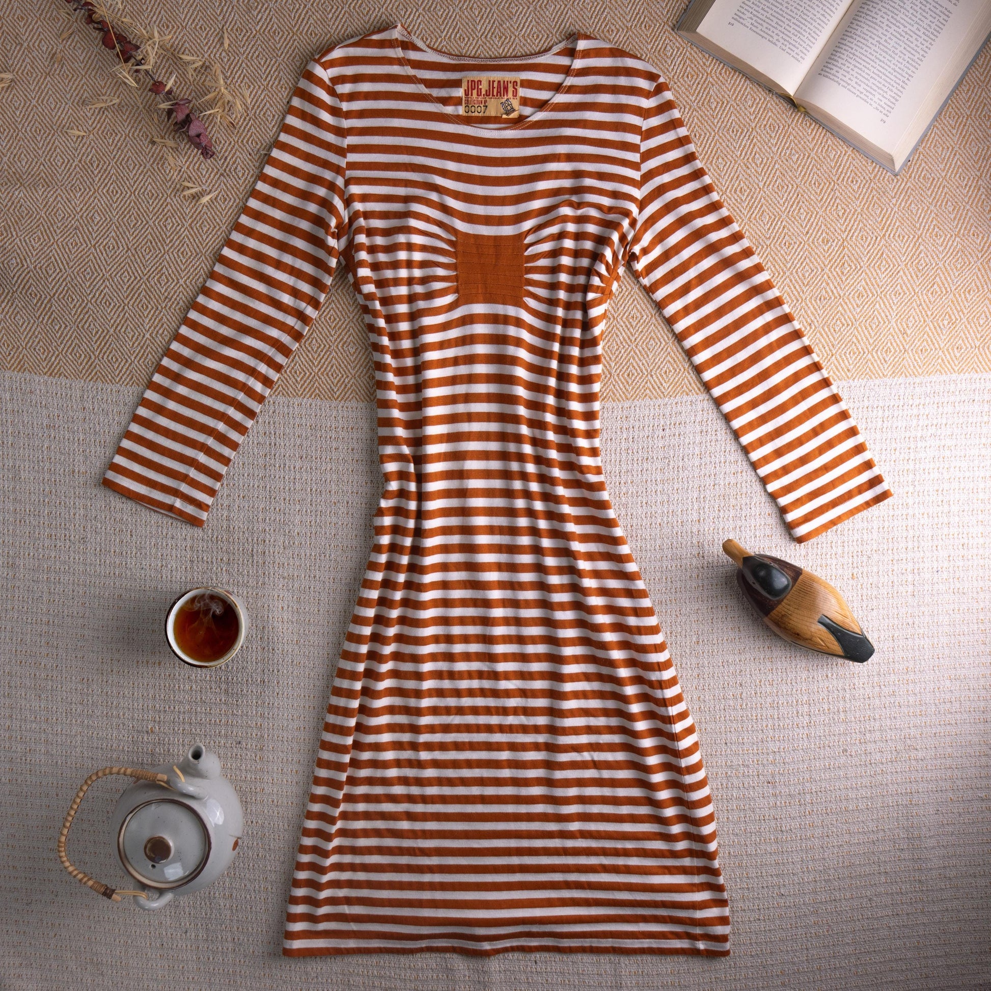 Jean Paul Gaultier JPG Jean's Archival 90s Marinière Stripe Midi Dress – rust orange and white horizontal stripe stretch jersey, optical illusion trompe l'oeil ruched bust effect, single chest patch pocket, scoop neckline, long sleeves, body-con midi silhouette, JPG Jean's Collection 0007 woven label, flat lay editorial shot