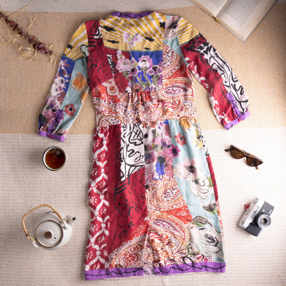 back view Museum Piece Archival Etro Milano S/S 2003 Silk Patchwork Midi Dress – pure silk, maximalist mixed-print patchwork combining crimson Moorish tile motif, abstract face line drawing, watercolour floral, yellow stripe, paisley and blue abstract panels, purple contrast trim at collar, cuffs and hem, hand-blown red glass buttons at placket, gathered empire waist, long sleeves, rare runway archive IT 42, flat lay editorial shot