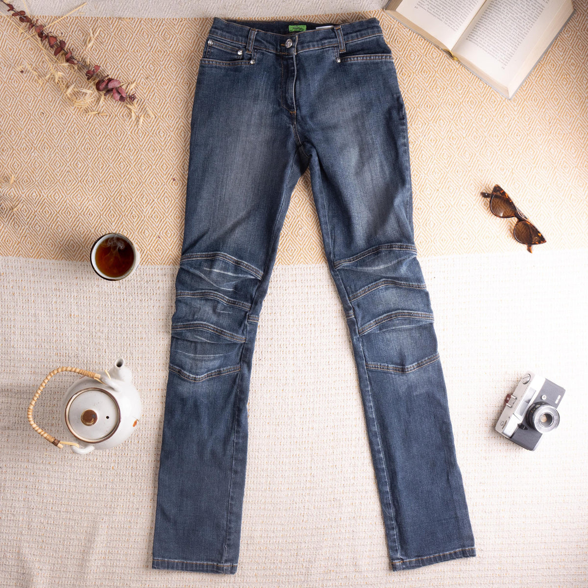 Archival Thierry Mugler Late 1990s Indigo Ribbed Biker Star Jeans – mid-wash indigo stretch denim, low rise with single star button and zip fly, five-pocket construction, triple horizontal ribbed moto panel seaming at both knees, slim straight leg silhouette, hourglass fit, Mugler green label, IT 27 W26-27, flat lay editorial shot