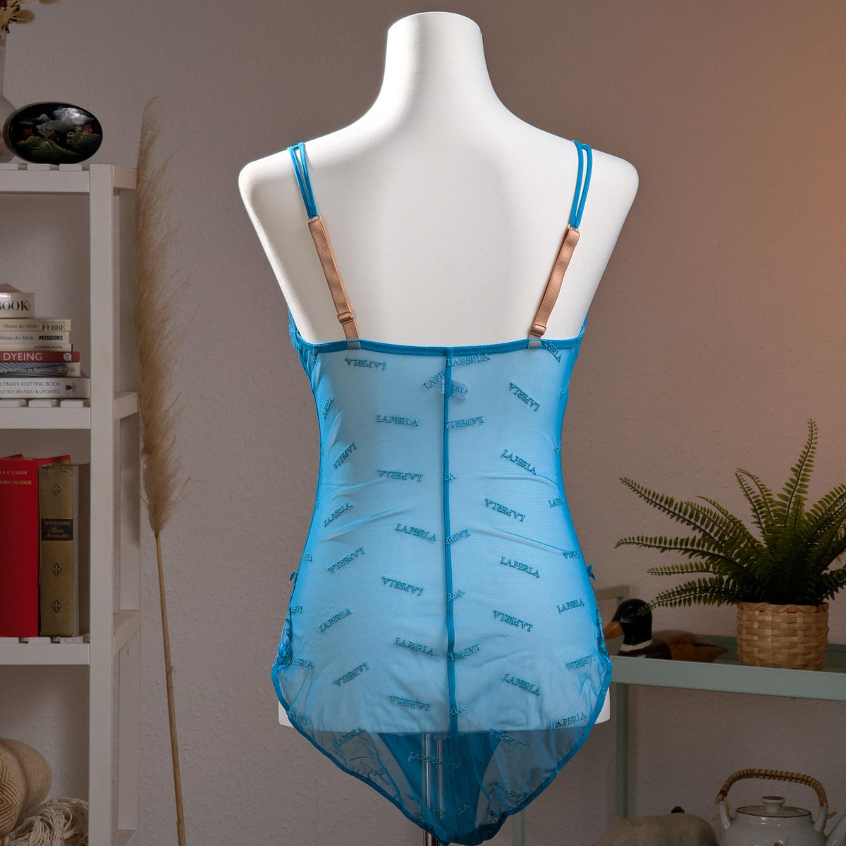 back view Archival La Perla Y2K Monogram Mesh Bodysuit – vibrant cyan blue sheer mesh with all0over tonal "La Perla" script monogram print, underwired moulded cups, V-neckline, wide shoulder straps, ruched side detail, thong cut, Italian designer lingerie masterpiece, product shot on dress form