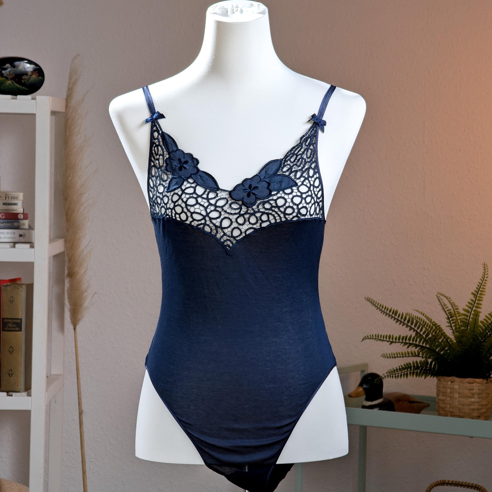 Archival La Perla Tricot NOS Deadstock 90s Navy Blue Bodysuit – navy blue stretch jersey with sheer guipure lace décolleté panel featuring 3D appliqué floral embroidery, adjustable spaghetti straps with bow detail, V-neckline, thong cut, Italian museum grade lingerie, product shot on dress form