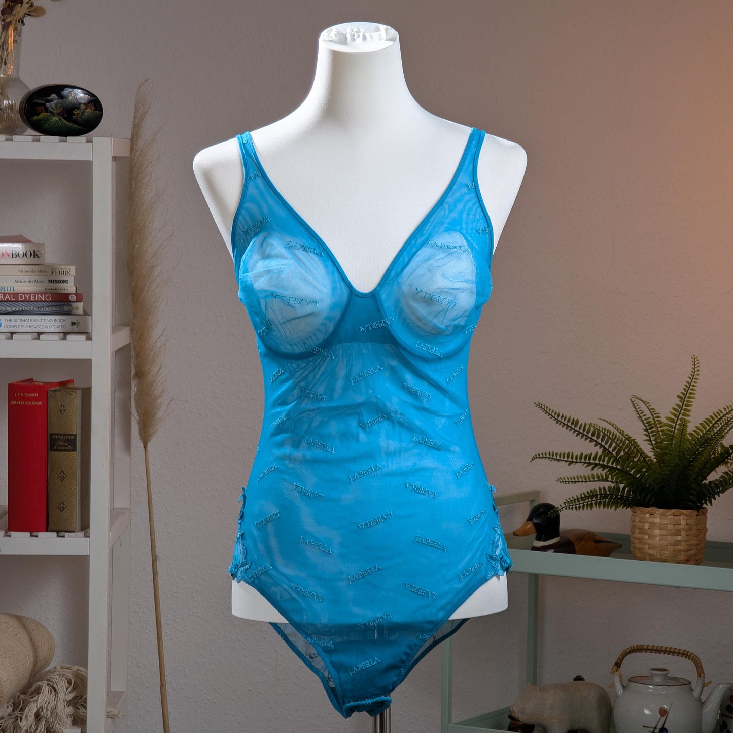 Archival La Perla Y2K Monogram Mesh Bodysuit – vibrant cyan blue sheer mesh with all0over tonal "La Perla" script monogram print, underwired moulded cups, V-neckline, wide shoulder straps, ruched side detail, thong cut, Italian designer lingerie masterpiece, product shot on dress form