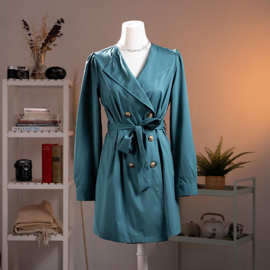 Archival Oscar de la Renta NOS Deadstock 90s Trench Mini Dress – petrol teal blue gabardine, wide lapel V-neckline, double-breasted with gold logo buttons, long sleeves with puff shoulder detail, self-tie waist belt, A-line mini silhouette, product shot on dress form