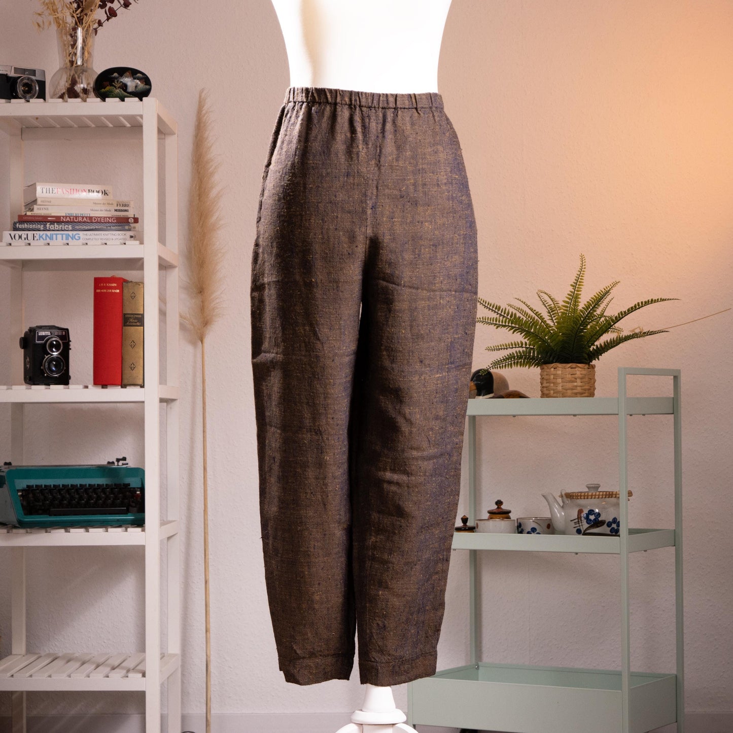 Archival Pierre Balmain Boutique 90s Linen Trousers – dark brown melange linen with subtle flecked texture, elasticated high waist, relaxed tapered leg, side pockets, cropped ankle length, product shot on dress form