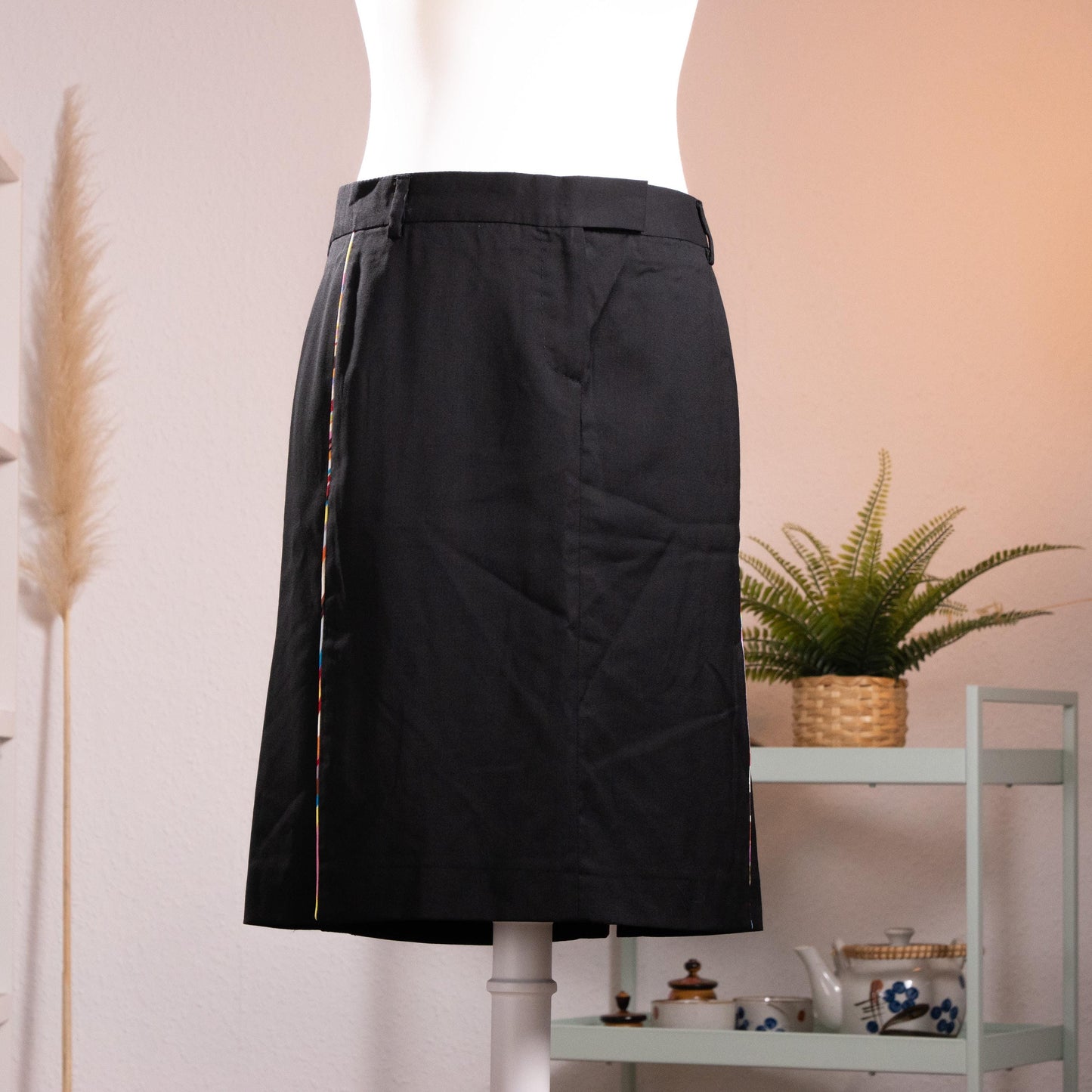 NOS Archival Paul Smith Black Label Merino Wool Pencil Skirt – jet black fine merino wool, high waist with belt loops and hook-and-bar closure, signature Paul Smith multicolour rainbow stripe trim along dual front kick-split vents, straight pencil silhouette, NOS deadstock, Made in Italy, product shot on dress form
