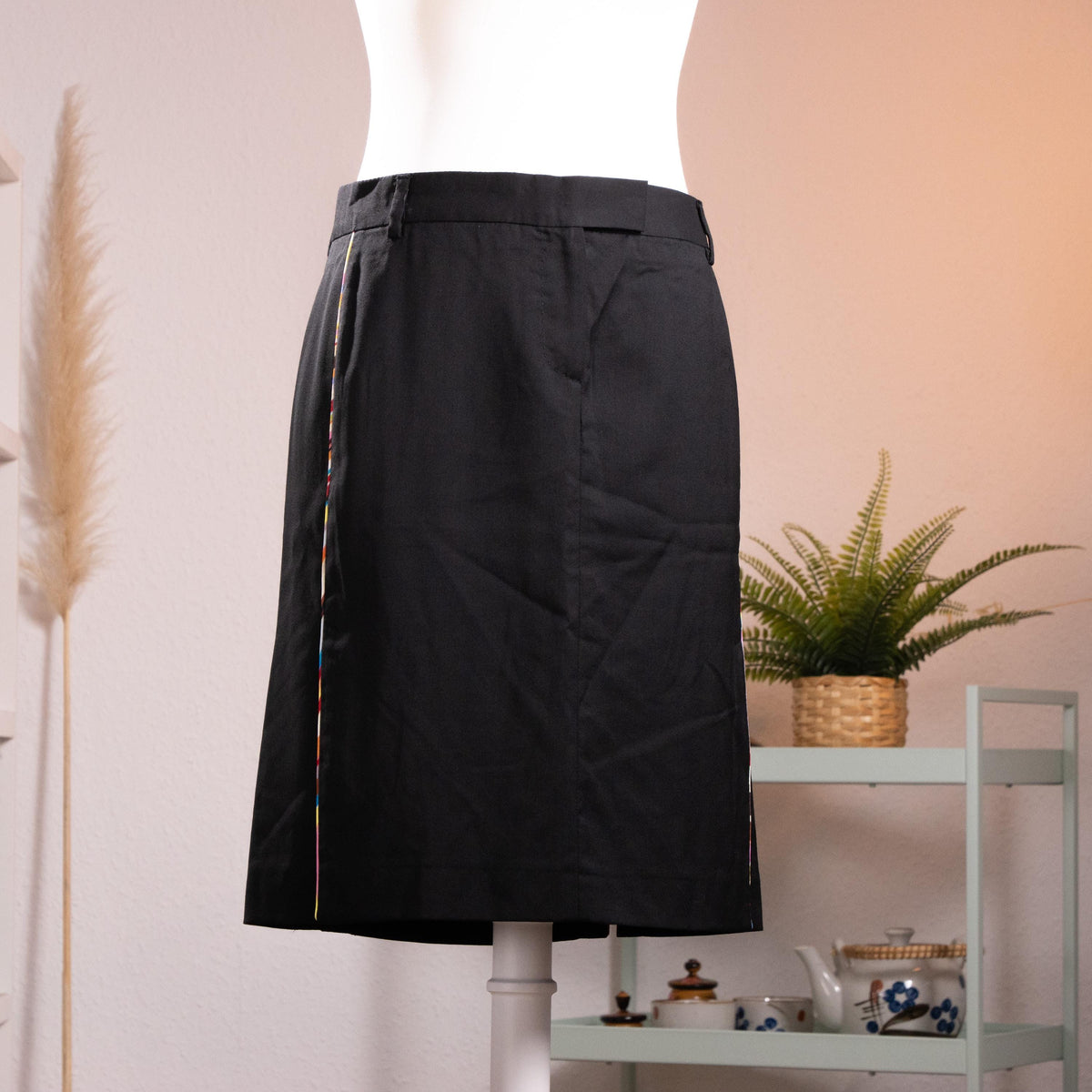 NOS Archival Paul Smith Black Label Merino Wool Pencil Skirt – jet black fine merino wool, high waist with belt loops and hook-and-bar closure, signature Paul Smith multicolour rainbow stripe trim along dual front kick-split vents, straight pencil silhouette, NOS deadstock, Made in Italy, product shot on dress form