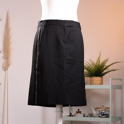 NOS Archival Paul Smith Black Label Merino Wool Pencil Skirt – jet black fine merino wool, high waist with belt loops and hook-and-bar closure, signature Paul Smith multicolour rainbow stripe trim along dual front kick-split vents, straight pencil silhouette, NOS deadstock, Made in Italy, product shot on dress form