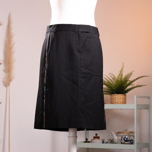 NOS Archival Paul Smith Black Label Merino Wool Pencil Skirt – jet black fine merino wool, high waist with belt loops and hook-and-bar closure, signature Paul Smith multicolour rainbow stripe trim along dual front kick-split vents, straight pencil silhouette, NOS deadstock, Made in Italy, product shot on dress form
