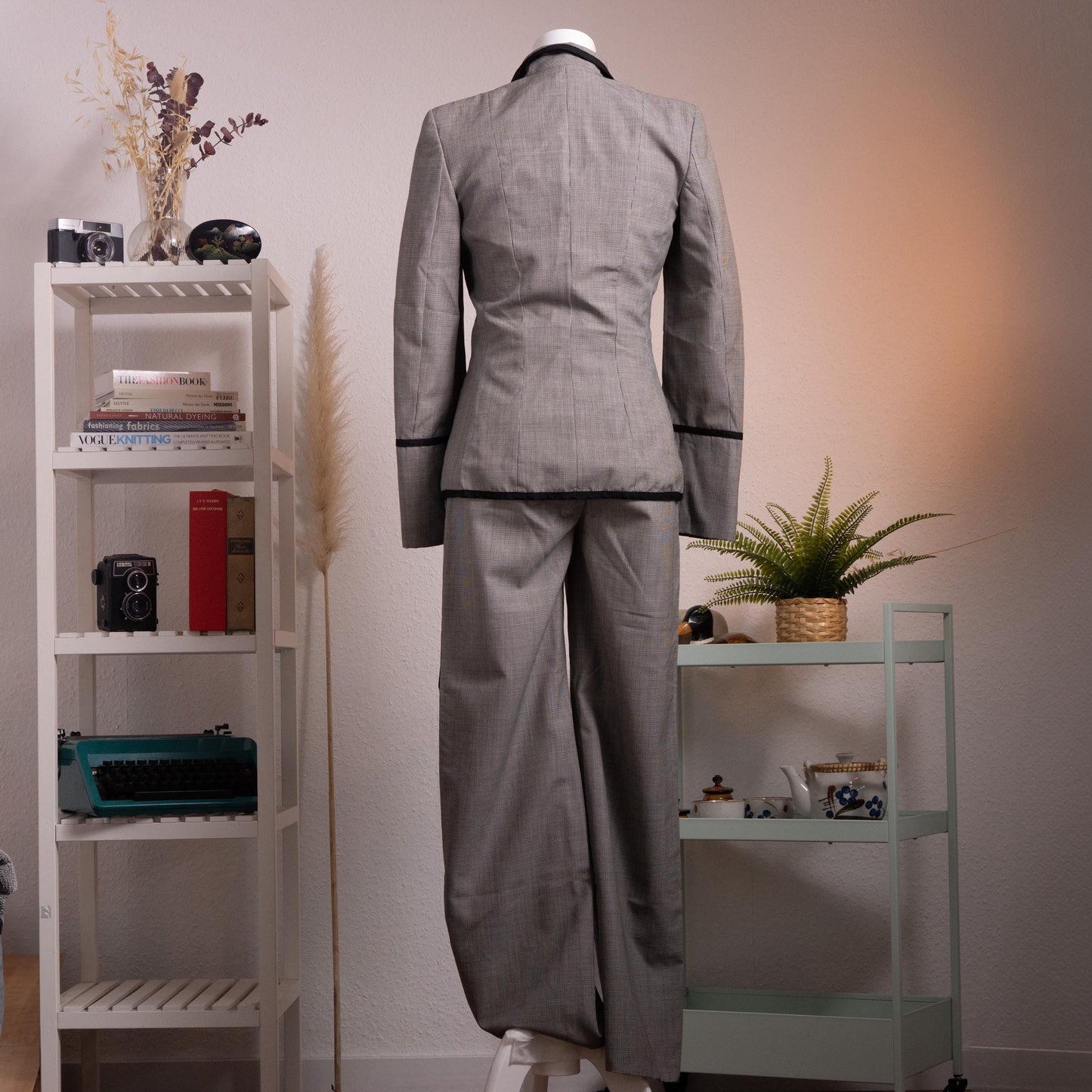 back view Archival Rena Lange RED 90s Virgin Wool Houndstooth Suit – silver grey fine virgin wool houndstooth blazer and wide-leg flared trousers set, notch lapel with black velvet piping trim, four silver coin buttons front, two piped flap pockets, wide turn-back cuffs with coin button detail, high-waist wide-leg trousers, Falber Italy, product shot on dress form
