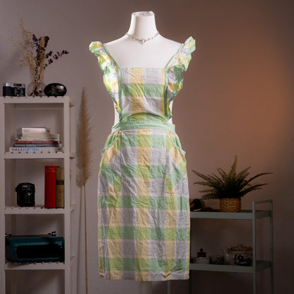 Archival Courrèges Paris 80s Japan License Metallic Lurex Gingham Pinafore Dress – oversized pastel check in mint green, butter yellow and white with metallic lurex shimmer, ruffled flutter shoulder straps, square neckline, open-back tabard silhouette with tie waist, two front patch pockets, midi length, rare Japan license piece, product shot on dress form
